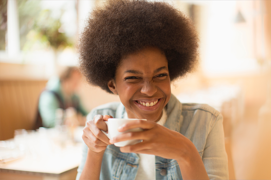 Beautiful smiling woman drinking coffee beverage