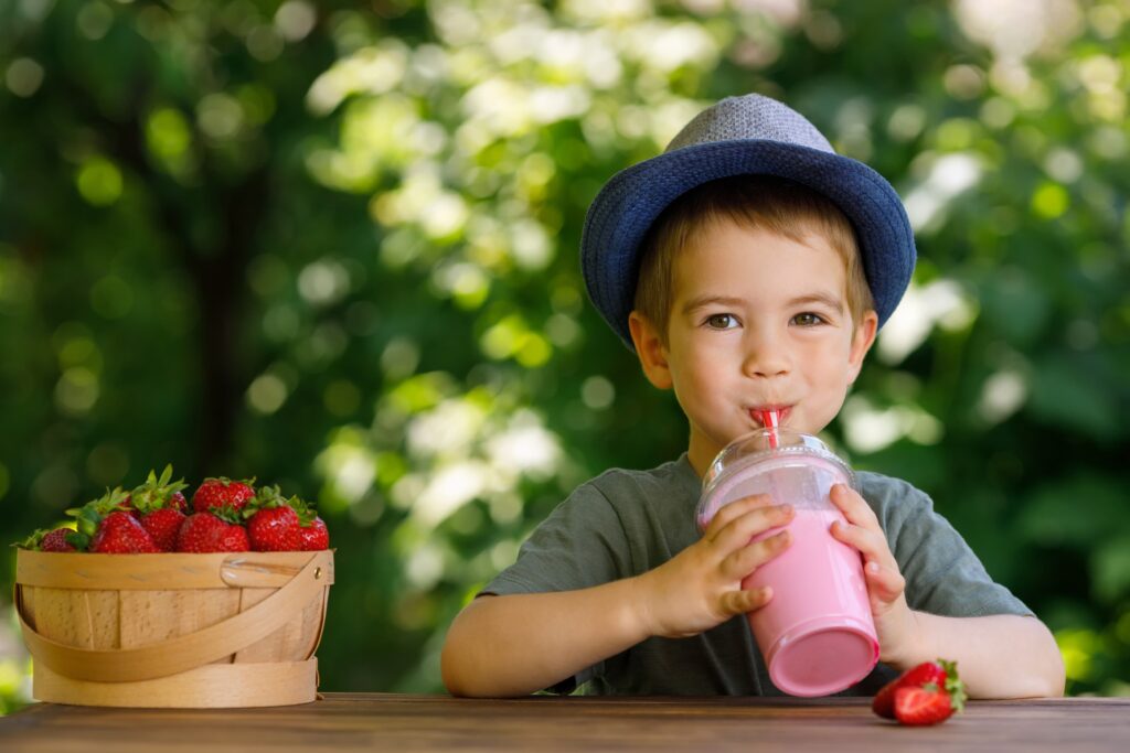 boy drinking strawberry milkshake, strawberry beverage flavors, natural strawberry flavor