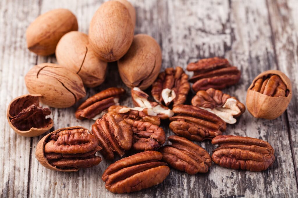 freshly shelled pecans on a wooden table, nut flavors without allergens