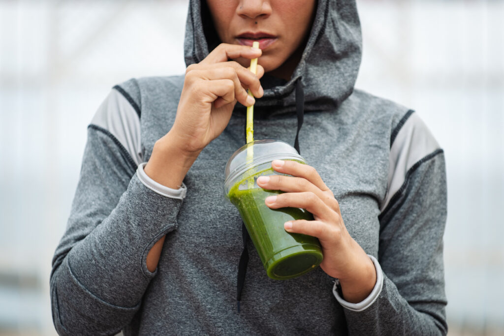 Urban Fitness Woman Drinking Detox Smoothie On Workout Rest