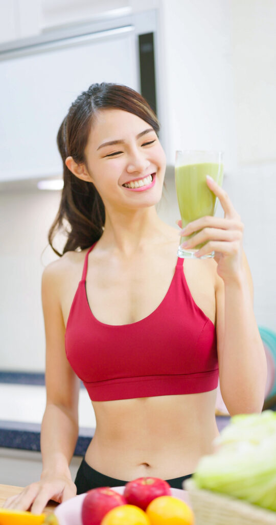 Woman Drinks Green Smoothie