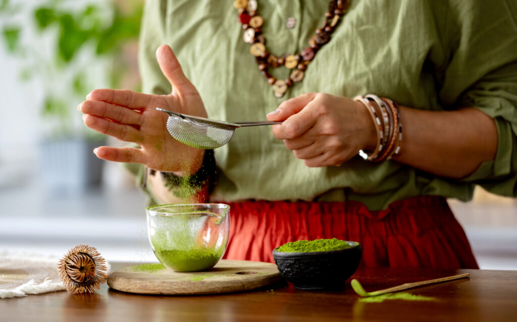 Woman Sifting Matcha Tea