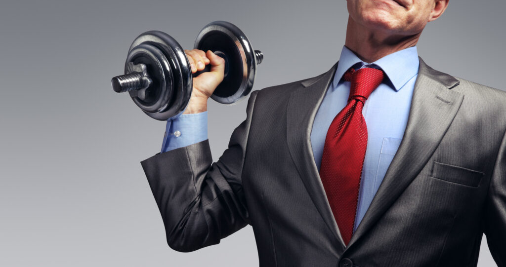 Image Of Businessman In Suit Raising Dumbbell. Tax Burden Concept