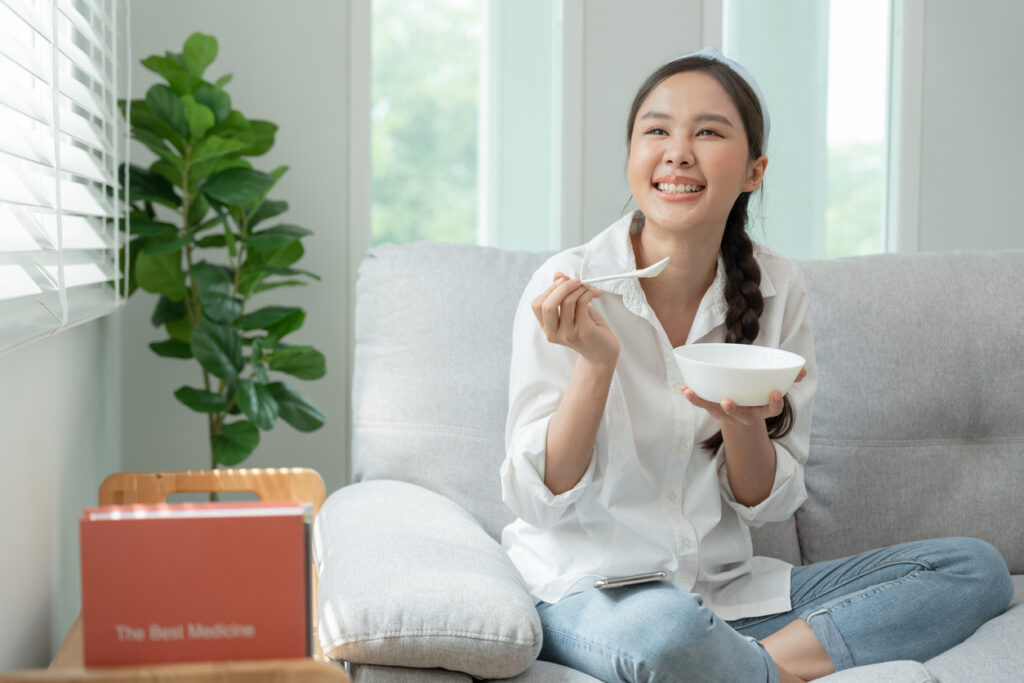 Healthy Food. Beautiful Female Girl Enjoy Eat Yogurt, Granola, Fresh Fruits On Breakfast Health In House. Happy Young Woman Smile On Morning Good Emotion. Dieting, Detox, Diet, Clean Eat, Vegetarian