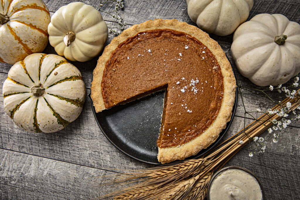 Pumpkin Pie And Autumn White Pumpkins With Babys Breath Flowers On Wood Background