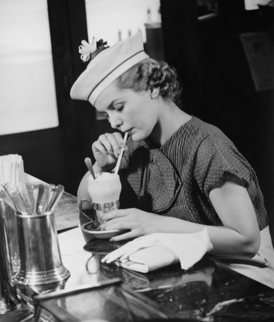 Young Woman In Fancy Hat Drinking Ice Cream Soda (b&w)